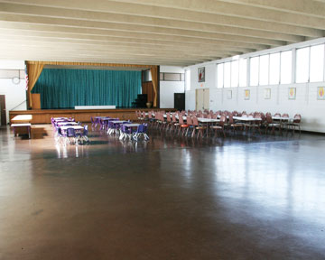 Jikoen social hall with tables and chairs set up for event, showing a lot of clear floor space