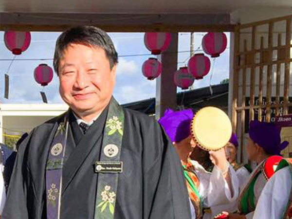 Rev. Shindo Nishiyama, outdoors, smiling